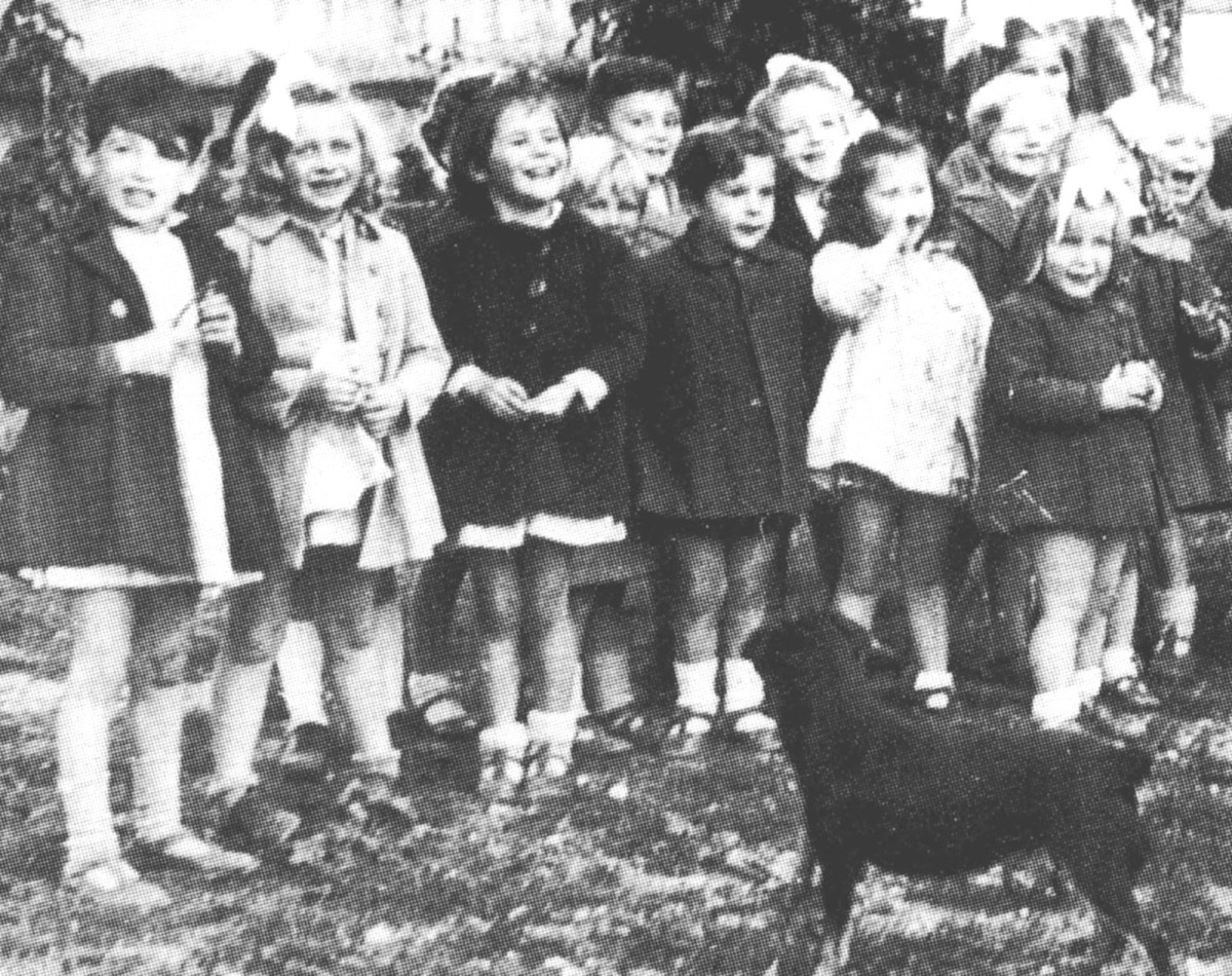 Raincy-le-Plateau orphanage 1946: Suzanne (second from left) with other children and their dog, Zezette.